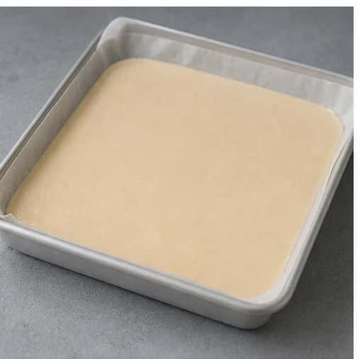 Step 3: Spread the mixture into a parchment-lined shallow container in a 1/2-inch (1.3 cm) layer and smooth the top.
