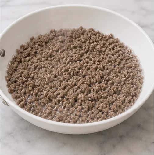 Step 2: Cook over medium-low heat, breaking the beef into very fine crumbles, until no pink remains and it reaches 160 degrees F (71.1 degrees C).