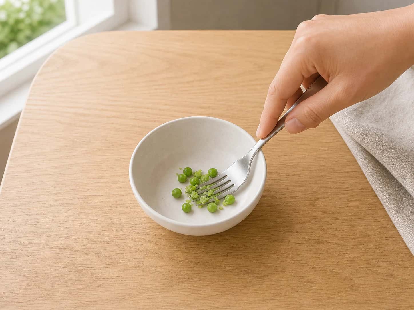 Step 4: Cover the frozen green peas with plain water in a small saucepan, bring to a gentle boil, and cook for 3 minutes. Drain well and lightly crush every pea with a fork; if any pea stays firm, simmer it for 1 to 2 minutes longer.